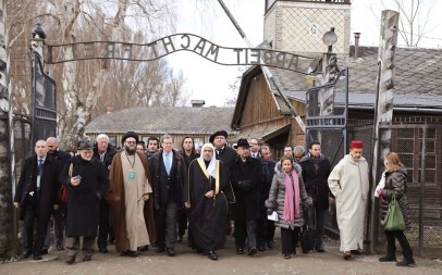 A delegation of Muslim religious leaders at the gate leading to the former Nazi German death camp of Auschwitz, together with a Jewish group in what organizers called “the most senior Islamic leadership delegation" to visit the former Nazi death camp, in Oswiecim, Poland, January 23, 2020. (American Jewish Committee via AP)
