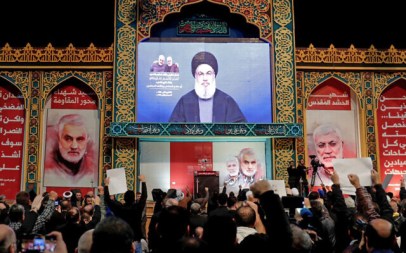 Supporters of Shiite Hezbollah terror group watch a speech by its leader Hasan Nasrallah, broadcast on a screen, in the Lebanese capital Beirut's southern suburbs, January 5, 2020. (Anwar Amro/AFP)