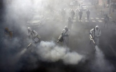 Iranian firefighters disinfect streets in the capital Tehran in a bid to halt the wild spread of coronavirus on March 13 2020. (AFP)