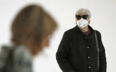 People wearing protective masks arrive at Samson Assuta Ashdod University Hospital on March 16, 2020, in the southern Israeli city of Ashdod. (JACK GUEZ / AFP)