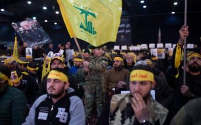 A child in tiny military fatigues waves the Hezbollah flag as supporters of the group's leader Sayyed Hassan Nasrallah wait for his televised speech in a southern suburb of Beirut, Lebanon, Sunday, Jan. 5, 2020 following the US airstrike in Iraq that killed Iranian Revolutionary Guard Gen. Qassem Soleimani. (AP Photo/Maya Alleruzzo)