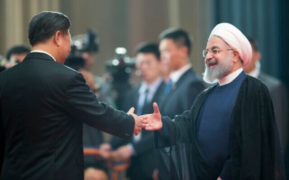Chinese President Xi Jinping, left, greets Iranian President Hassan Rouhani at the Shanghai Cooperation Organization (SCO) Summit in Qingdao in eastern China's Shandong Province on June 10, 2018. (AP Photo/Alexander Zemlianichenko)