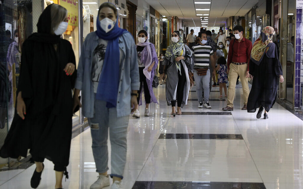 People wearing protective face masks to help prevent the spread of the coronavirus walk through the Nasr Shopping Center in Tehran, Iran, July 15, 2020 (AP Photo/Vahid Salemi)
