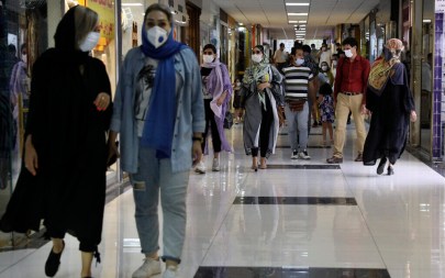 People wearing protective face masks to help prevent the spread of the coronavirus walk through the Nasr Shopping Center in Tehran, Iran, July 15, 2020 (AP Photo/Vahid Salemi)