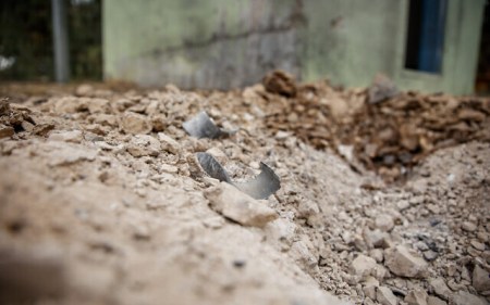Remains of a rocket fired from the Gaza Strip near houses on a kibbutz in southern Israel on April 24, 2021 (Flash90)