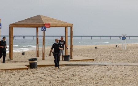 Israeli police officers walk on Zikim Beach close to the Gaza border after it was closed to visitors, on April 24, 2021 (Flash90)