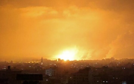 An explosion lights the sky following an Israeli air strike on Beit Lahia in the northern Gaza Strip early on May 14, 2021. (MOHAMMED ABED / AFP)