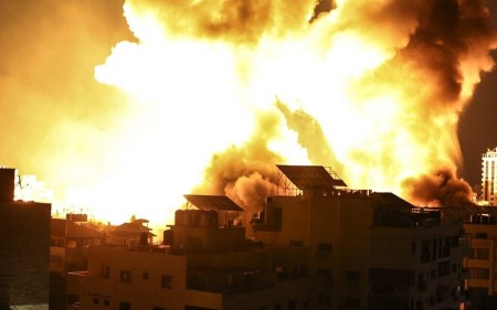 A ball of fire explodes above buildings in Gaza City as Israel shells the Palestinian enclave, early on May 18, 2021, amid fighting between the Israel Defense Forces and Gaza-ruling Hamas terror group. (Mahmud Hams/AFP)