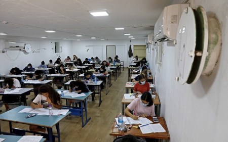 Students take their highschool exams inside a bomb shelter in the central Israeli village of Tzafria, May 20, 2021, amid rocket barrages from Hamas in Gaza and IDF counterstrikes. (Photo by Gil COHEN-MAGEN / AFP)