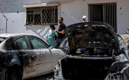 Relatives walk out of the damaged home of Nadine, 16, and Khalil Awaad, a father and daughter who were killed by a rocket fired from the Gaza Strip, in their village of Dahmash, May 12, 2021. (AP Photos/Heidi Levine)