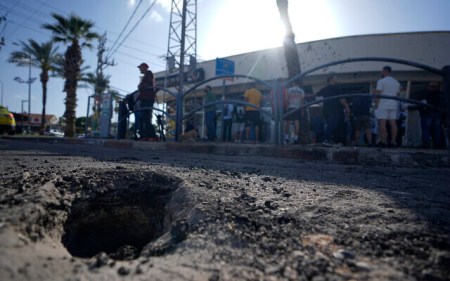The crater from an intercepted rocket fired from Lebanon that landed in Shlomi, northern Israel Thursday, April 6, 2023. (AP Photo/Ariel Schalit) The crater from an intercepted rocket fired from Lebanon that landed in Shlomi, northern Israel Thursday, April 6, 2023. (AP Photo/Ariel Schalit)