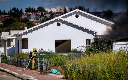 Firefighters work to extinguish a fire after a rocket fired from Lebanon hit the Israeli town of Shlomi, April 6, 2023.(Fadi Amun/Flash90)