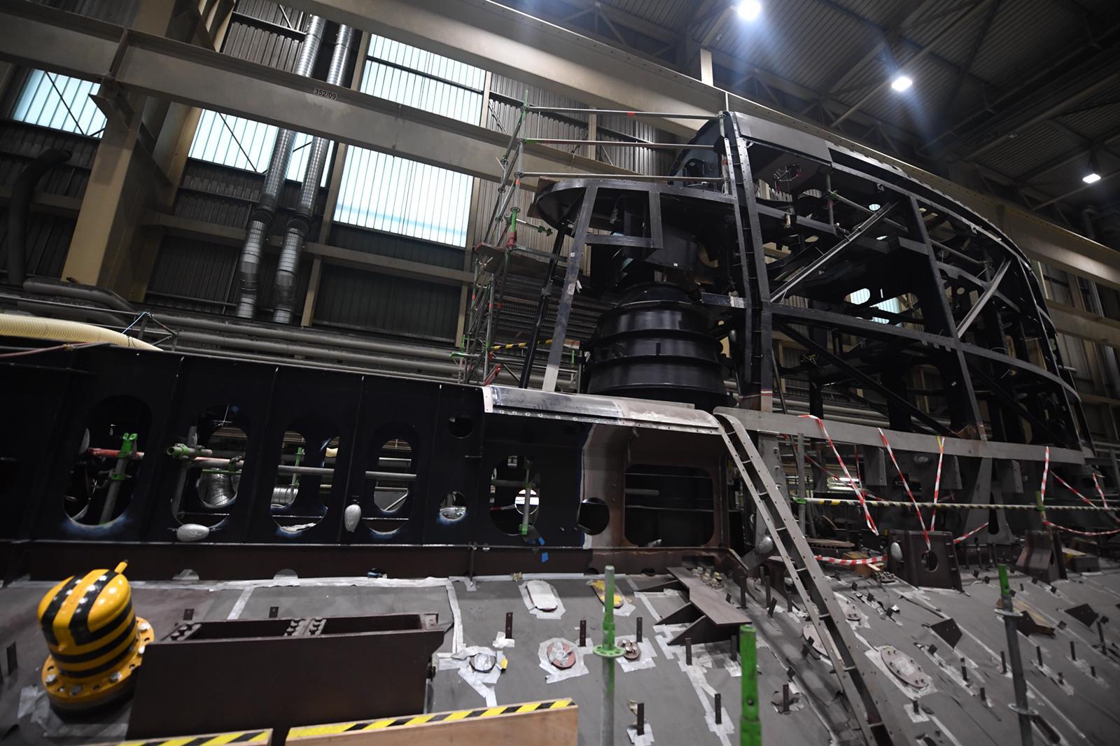 Two photos showing INS <em>Drakon</em> under construction, including the base of the large sail and the access hatch. <em>IDF</em>